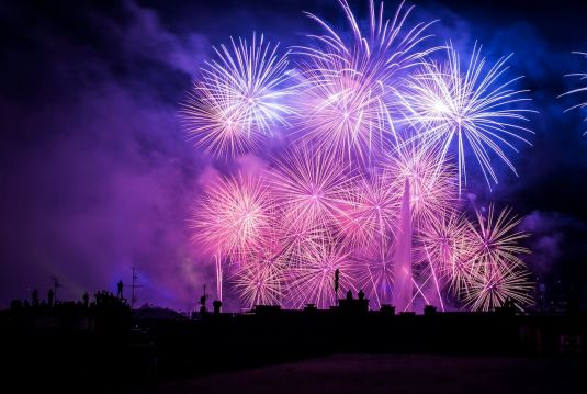 Blue and purple fireworks in the night sky