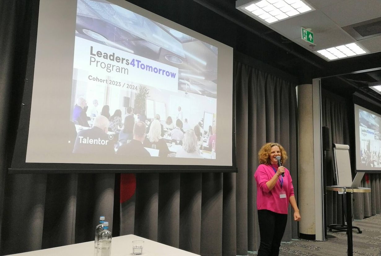 A woman holding a presentation with a microphone in her hand