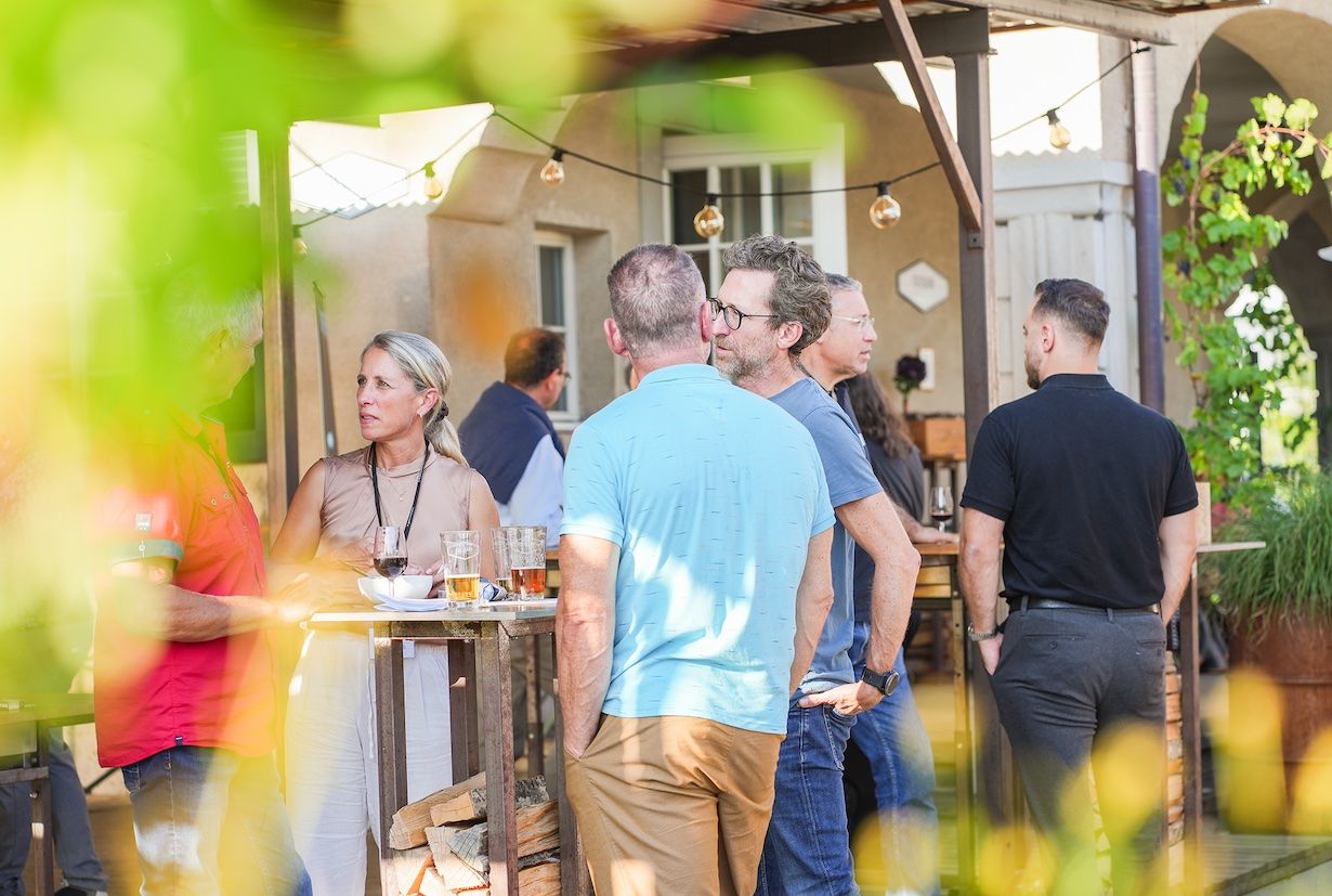 Apéro with guests standing at bar tables and chatting