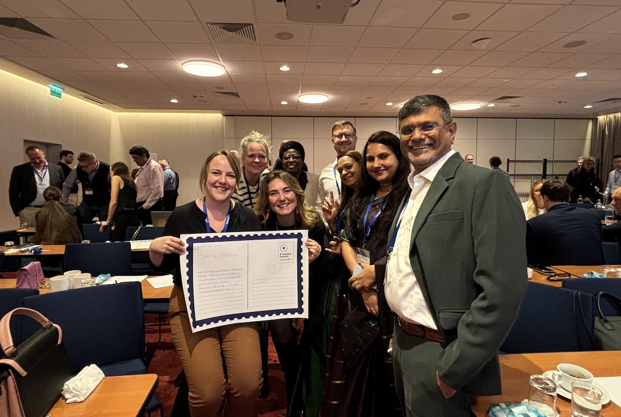 Group of people showing the poster card they made in a group workshop